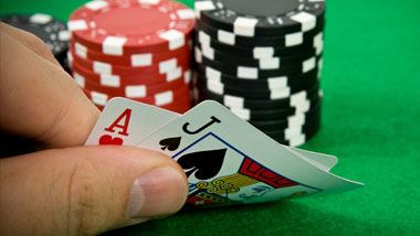 hand holding 2 cards with chips