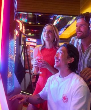 Three people at slot machine