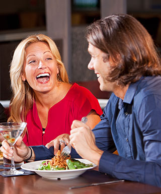 2 people enjoyinh a meal