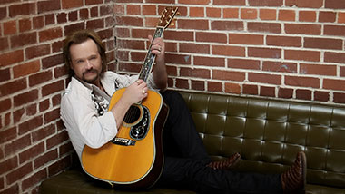Travis Tritt with a guitar