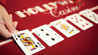 Four Playing Cards on red table