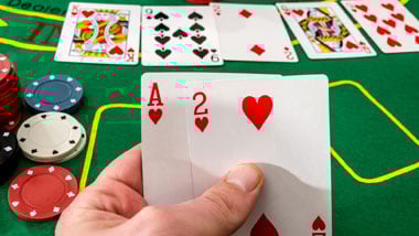 fingers holder cards, cards and chips on table