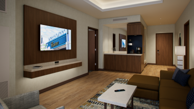 a living room suite with tv couch and wet bar